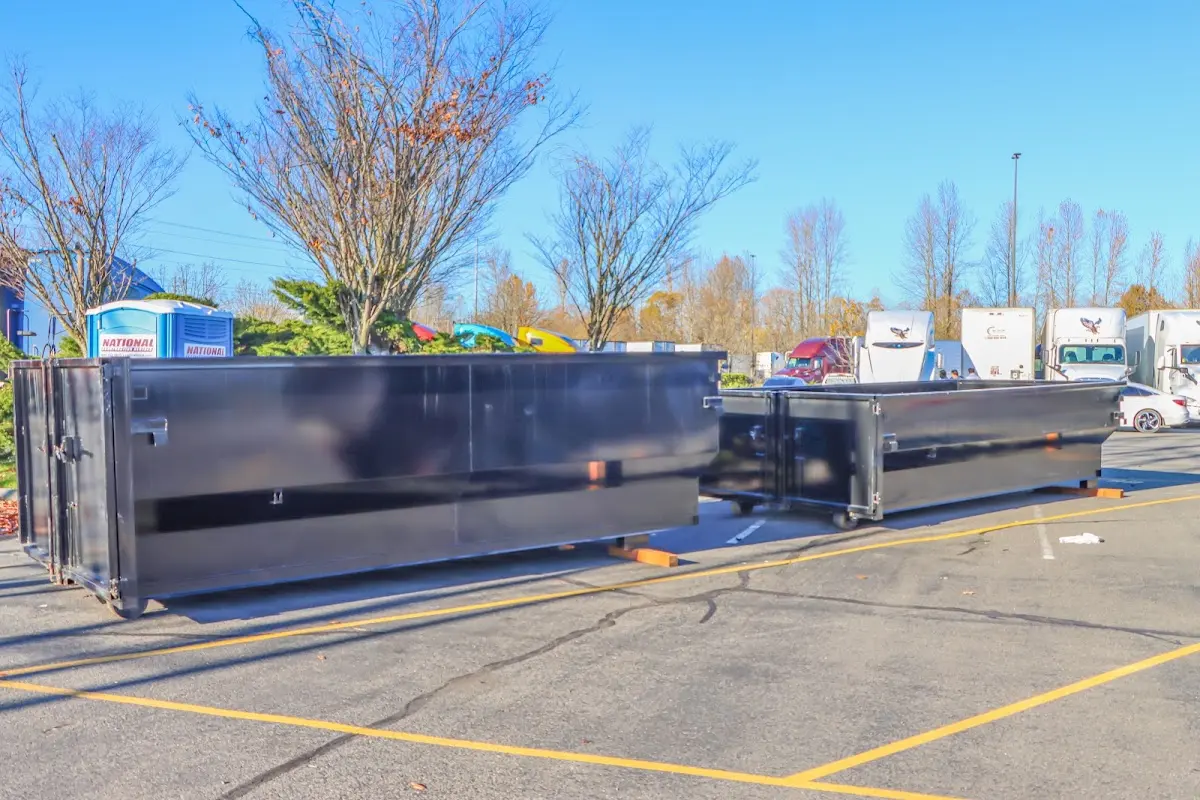 Professional dumpster rental service with roll-off container on residential driveway in West Little River